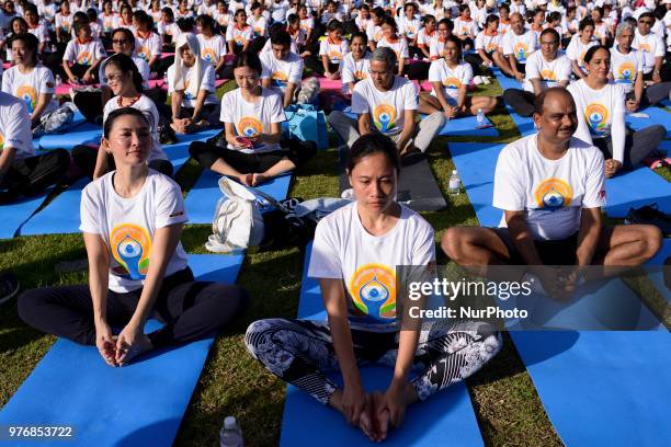 Thousands of people participate in a yoga exercise at Chulalongkorn University field, marking the International Day of Yoga in Bangkok, Thailand. 17...