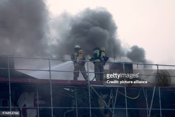 Firefighters work to extinguish a fire broke out on the hall of the former slaughterhouse at the Landsberger Allee, in Berlin, Germany, 14 April...