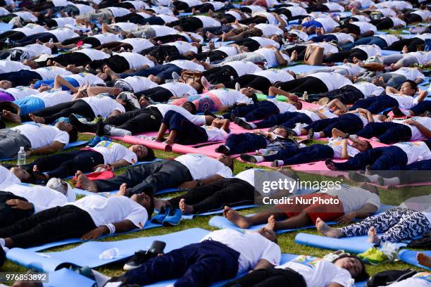 Thousands of people participate in a yoga exercise at Chulalongkorn University field, marking the International Day of Yoga in Bangkok, Thailand. 17...