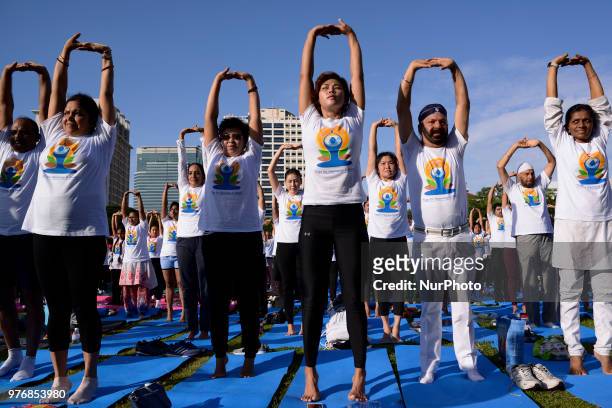 Thousands of people participate in a yoga exercise at Chulalongkorn University field, marking the International Day of Yoga in Bangkok, Thailand. 17...