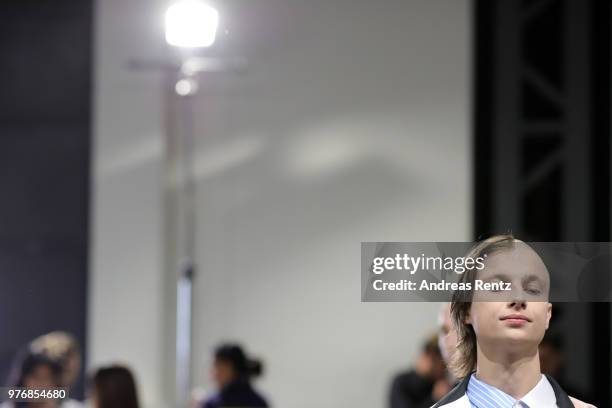 Model is seen backstage ahead of the Besfxxk show during Milan Men's Fashion Week Spring/Summer 2019 on June 17, 2018 in Milan, Italy.