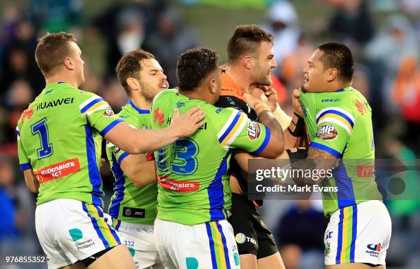 Tim Grant of the Tigers brawls with Joey Leilua of the Raiders during the round 15 NRL match between the Wests Tigers and the Canberra Raiders at...