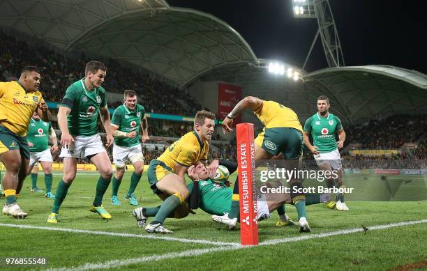 Ireland's Keith Earls knocks on whilst attempting to ground the ball under pressure from Bernard Foley of Australia during the International test...