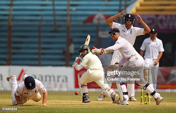 Bangladesh batsman Mushfiqur Rahim picks up some runs watched by Matt Prior and Alastair Cook during day three of the 1st Test match between...