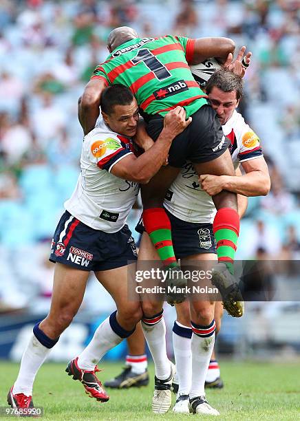 Sam Perrett and Mitchell Pearce of the Roosters tackle Rhys Wesser during the round one NRL match between the South Sydney Rabbitohs and the Sydney...