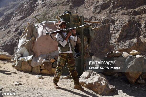 Member of a local militia armed with an RPG rocket launcher in front of a makeshift bunker, outpost to protect the lapis lazuli mines, located...