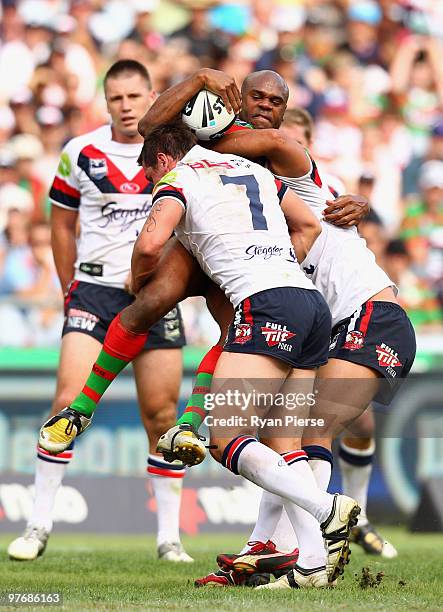 Rhys Wesser of the Rabbitohs is tackled by Mitchell Pearce of the Roosters during the round one NRL match between the South Sydney Rabbitohs and the...