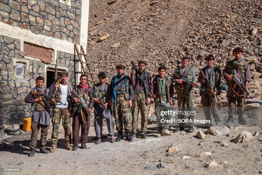 Armed men of a local militia at an outpost to protect the...