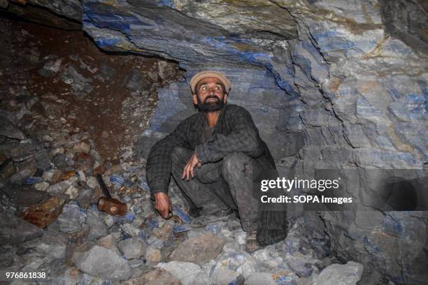 Mahdan-i Lojward a miner checking the lapis lazuli deposits enclosed in the rock of a tunnel of the mine "Junduk". Over the past years the government...