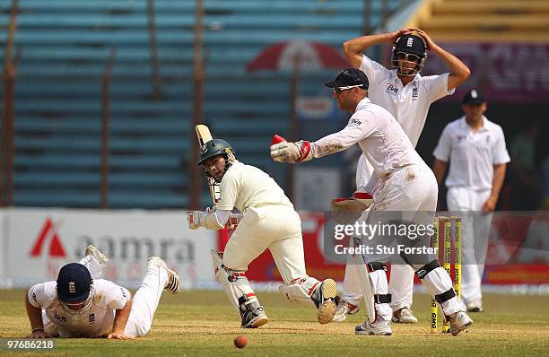 Bangladesh batsman Mushfiqur Rahim picks up some runs watched by Matt Prior and Alastair Cook during day three of the 1st Test match between...