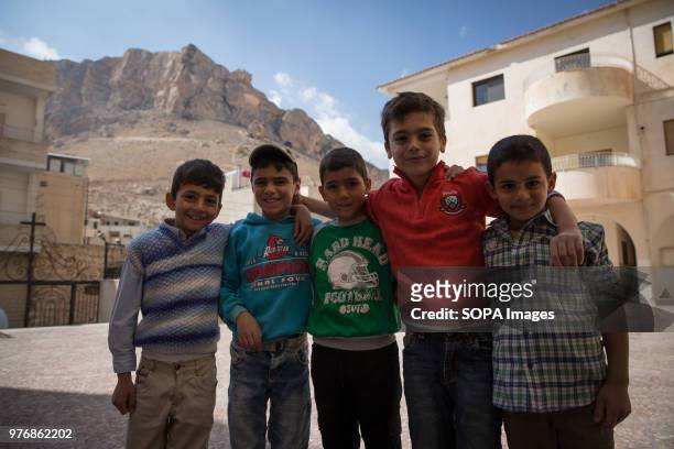 Children pose outside church on a Sunday in Maaloula, the Christian town where Aramaic, the language of Jesus, is still spoken. Maaloula, a Christian...