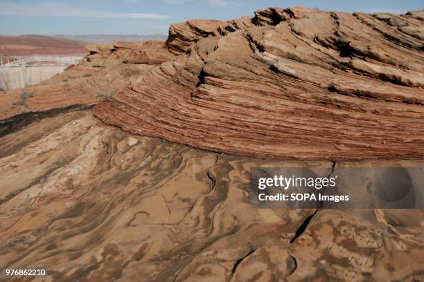View of the sandstone layers. Tourism in the Glen Canyon National Recreation area near Lake Powell comprises of the sandstone layers formed million...