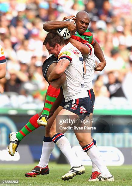 Rhys Wesser of the Rabbitohs is tackled by Mitchell Pearce of the Roosters during the round one NRL match between the South Sydney Rabbitohs and the...