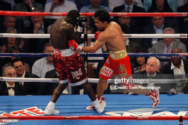 Manny Pacquiao of the Philippines throws a left to the body of Joshua Clottey of Ghana during the WBO welterweight title fight at Cowboys Stadium on...