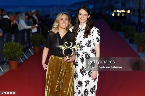 Winner of the Youth Award Marie Monge and Stacy Martin attends the winners' red carpet of Cabourg Film Festival on June 16, 2018 in Cabourg, France.