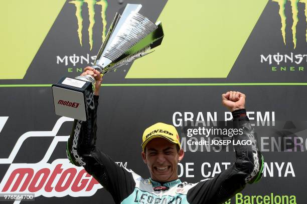 Honda Leopard Racing Italian's rider Ena Bastianini celebrates on the podium with the trophy after winning the Catalunya Moto3 Grand Prix race at the...