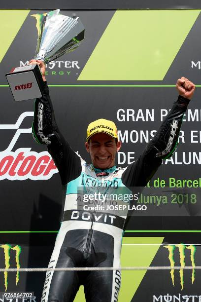 Honda Leopard Racing Italian's rider Ena Bastianini celebrates on the podium with the trophy after winning the Catalunya Moto3 Grand Prix race at the...