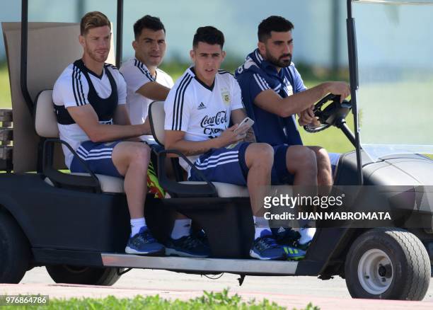 Argentina's defender Cristian Ansaldi defender Marcos Acuna midfielder Cristian Pavon and the team's press manager Nicolas Novello arrive for a...