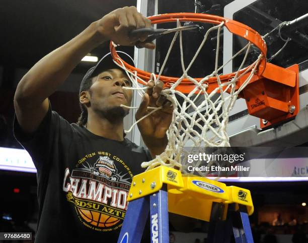 Kawhi Leonard of the San Diego State Aztecs cuts down the net after defeating the UNLV Rebels 55-45 in the championship game of the Conoco Mountain...