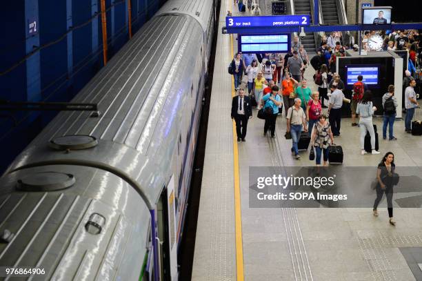 People walk by a platform at the Warsaw central station.