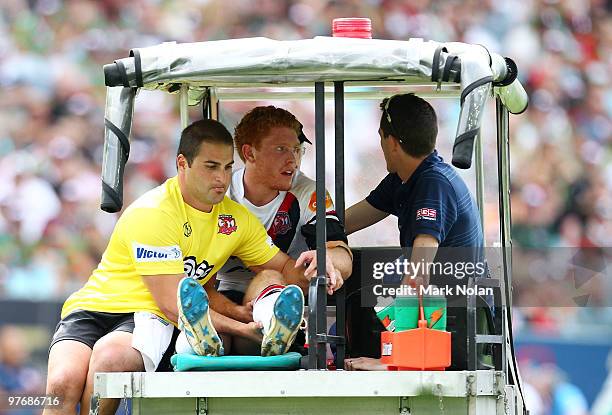 Tom Symonds of the Roosters is taken from the field after injuring his leg during the round one NRL match between the South Sydney Rabbitohs and the...