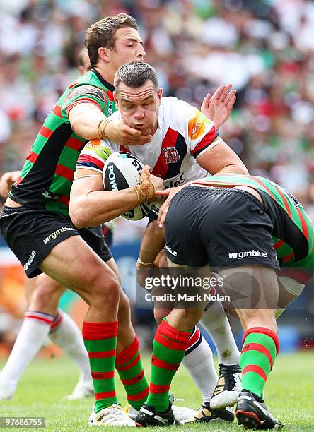Jason Ryles of the Roosters is tackled during the round one NRL match between the South Sydney Rabbitohs and the Sydney Roosters at ANZ Stadium on...