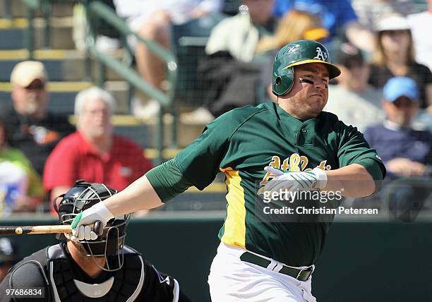 Jack Cust of the Oakland Athletics bats against the Chicago White Sox during the MLB spring training game at Phoenix Municipal Stadium on March 10,...