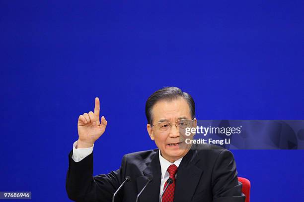 China's Premier Wen Jiabao gestures as he answers a question during his annual press conference after the closing of the National People's Congress...