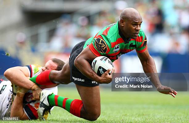 Rhys Wesser of the Rabbitohs is tackled during the round one NRL match between the South Sydney Rabbitohs and the Sydney Roosters at ANZ Stadium on...