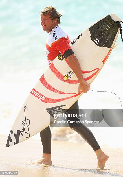 Taj Burrow of Australia walks up the beach following a heat during the Boost Bondi Beach SurfSho at Bondi Beach on March 14, 2010 in Sydney,...