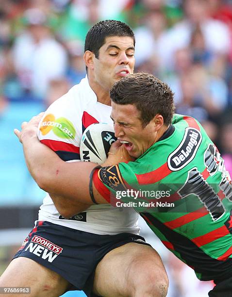 Nick Kouparitsas of the Roosters is tackled by Sam Burgess of the Rabbitohs during the round one NRL match between the South Sydney Rabbitohs and the...