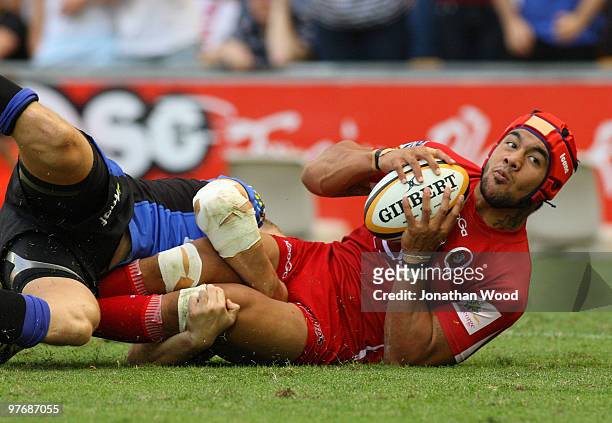 Digby Ioane of the Reds looks to get a pass away during the round five Super 14 match between the Reds and the Western Force at Suncorp Stadium on...