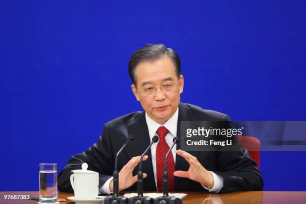 China's Premier Wen Jiabao gestures as he answers a question during his annual press conference after the closing of the National People's Congress...