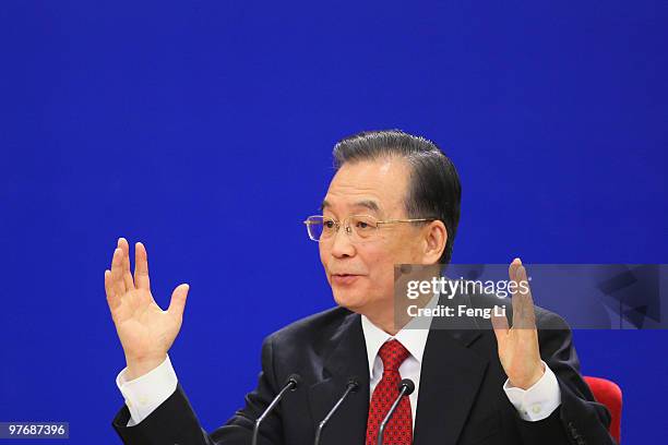 China's Premier Wen Jiabao gestures as he answers a question during his annual press conference after the closing of the National People's Congress...