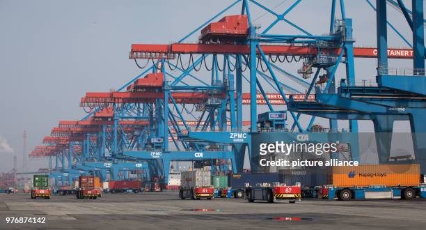 April 2018, Germany, Hamburg: A A container transporter powered by lithium-ion batteries at the Container Terminal Altenwerder . On Monday, Hamburg's...