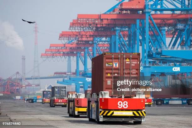 April 2018, Germany, Hamburg: Automatic container transporters at the Container Terminal Altenwerder . On Monday, Hamburg's Environment Senator...