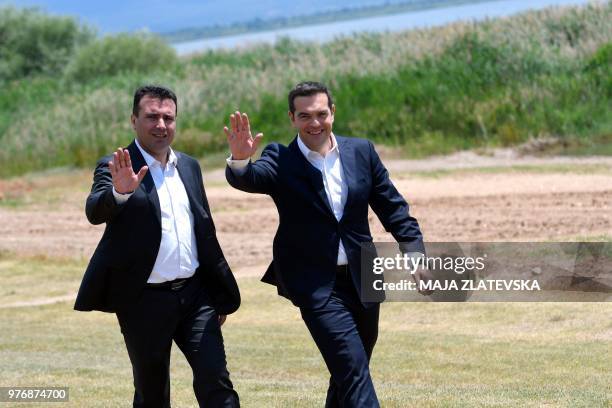 Macedonian Prime Minister Zoran Zaev welcomes Greek Prime Minister Alexis Tsipras on the shore of the Lake Prespa near Otesevo on June 17, 2018. The...