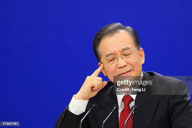 China's Premier Wen Jiabao gestures as he answers a question during his annual press conference after the closing of the National People's Congress...