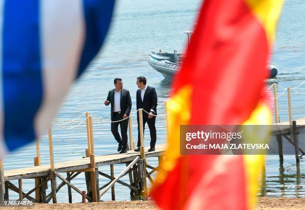 Macedonian Prime Minister Zoran Zaev welcomes Greek Prime Minister Alexis Tsipras on the shore of the Lake Prespa near Otesevo on June 17, 2018. -...