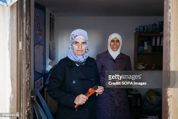 Safa'a and Hala standing with their plumbing tools. Zaatari is a refugee camp in northern Jordan, home to 80.000 civilians escaping war in Syria....