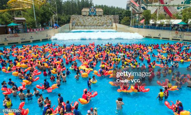 People play with crayfish inflatables at Playa Maya water park on June 17, 2018 in Wuhan, Hubei Province of China.