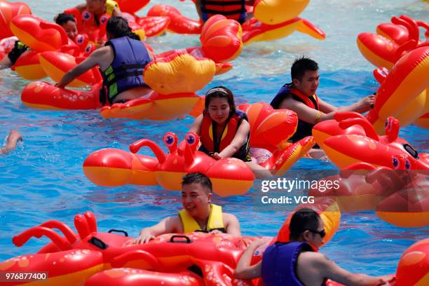 People play with crayfish inflatables at Playa Maya water park on June 17, 2018 in Wuhan, Hubei Province of China.