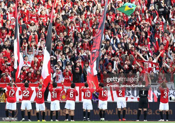 Players of Urawa Red Diamonds greet their fans after winning the J.League match between Urawa Red Diamonds and Tokyo F.C. At Saitama Stadium on March...