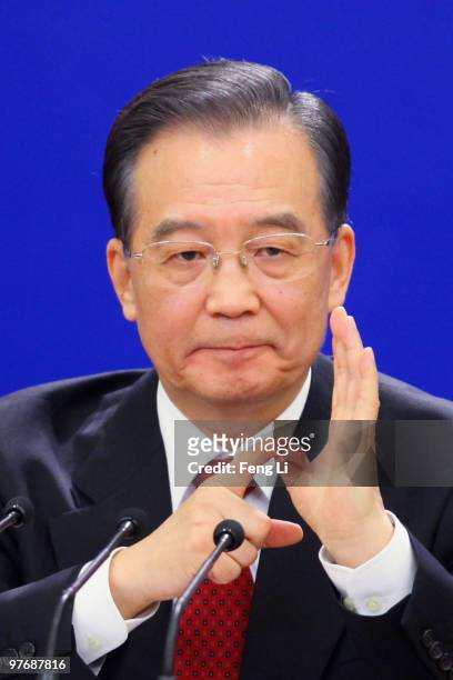 China's Premier Wen Jiabao gestures as he answers a question during his annual press conference after the closing of the National People's Congress...