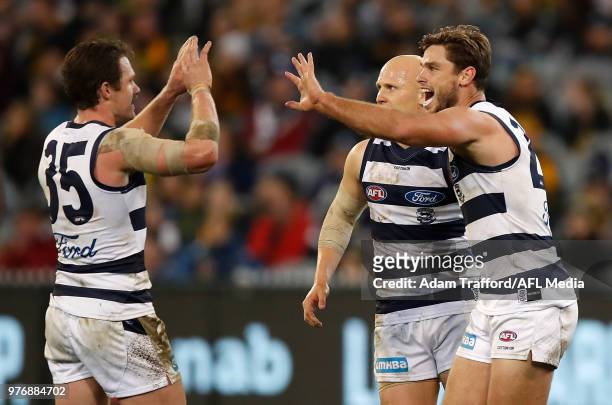 Tom Hawkins of the Cats celebrates a goal with Patrick Dangerfield and Gary Ablett of the Cats during the 2018 AFL round 13 match between the Geelong...