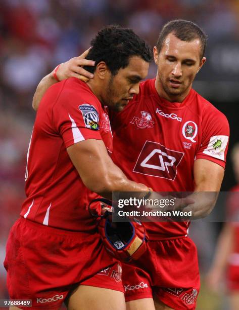 Quade Cooper and Digby Ioane of the Reds leave the field during the round five Super 14 match between the Reds and the Western Force at Suncorp...