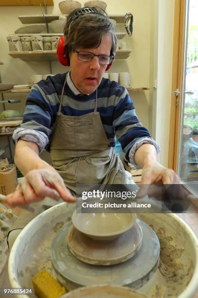 April 2018, Germany, Nuremberg: The autist Horst works on the potter's wheel at the Goldbach workshop in Nuremberg, a workshop for disabled people....