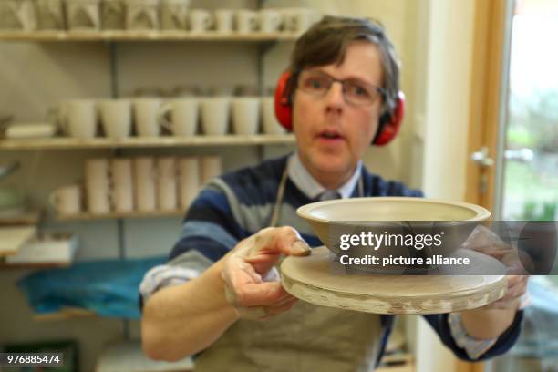 April 2018, Germany, Nuremberg: The autist Horst presents a selfmade bowl at the pottery of the Goldbach workshop in Nuremberg, a workshop for...
