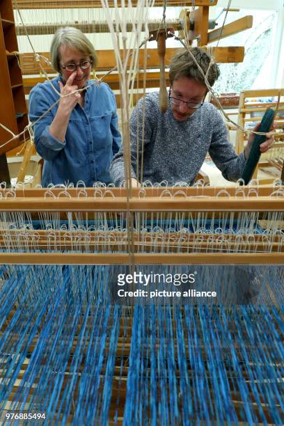 April 2018, Germany, Nuremberg: Philipp, a mentally and physically disabled teenager, working on a loom in the weaving mill of the Goldbach workshop...