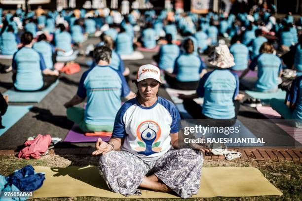Hundreds of people take part in a yoga session at North Beach on June 17, 2018 in Durban, South Africa, ahead of the International Day of Yoga on...